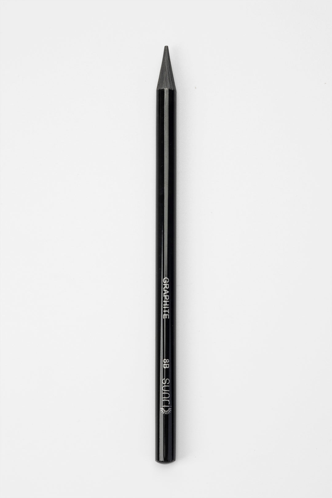 single black woodless graphite sketching pencil upright showing full length and tip
