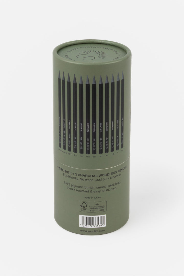 Green cylindrical container with charcoal pencils on a white background