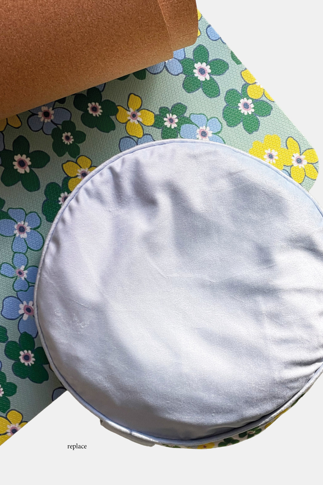close up of yoga mat in daisy floral pattern with meditation cushion on top
